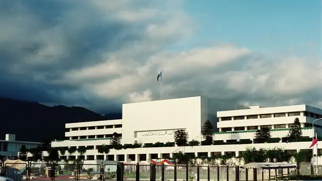 Parliament House in Islamabad, seat of the National Assembly and Senate of Pakistan, with the Margalla Hills behind it.